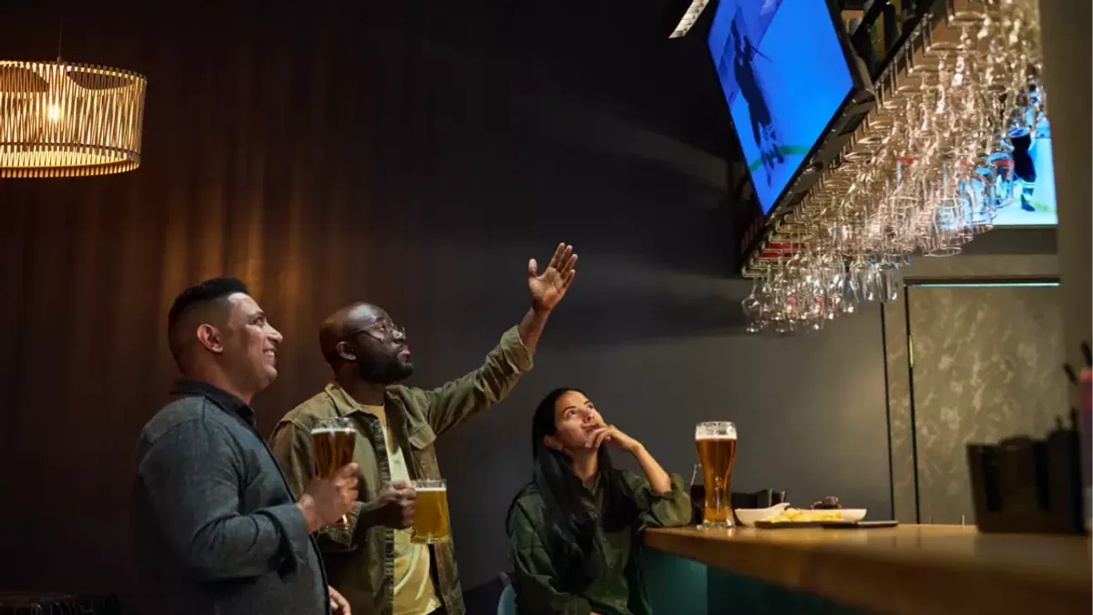 Fans watching the game on TVs in a busy sports bar