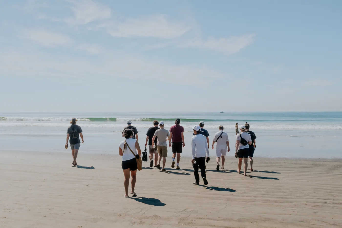 Taiv teammates walking along the beach