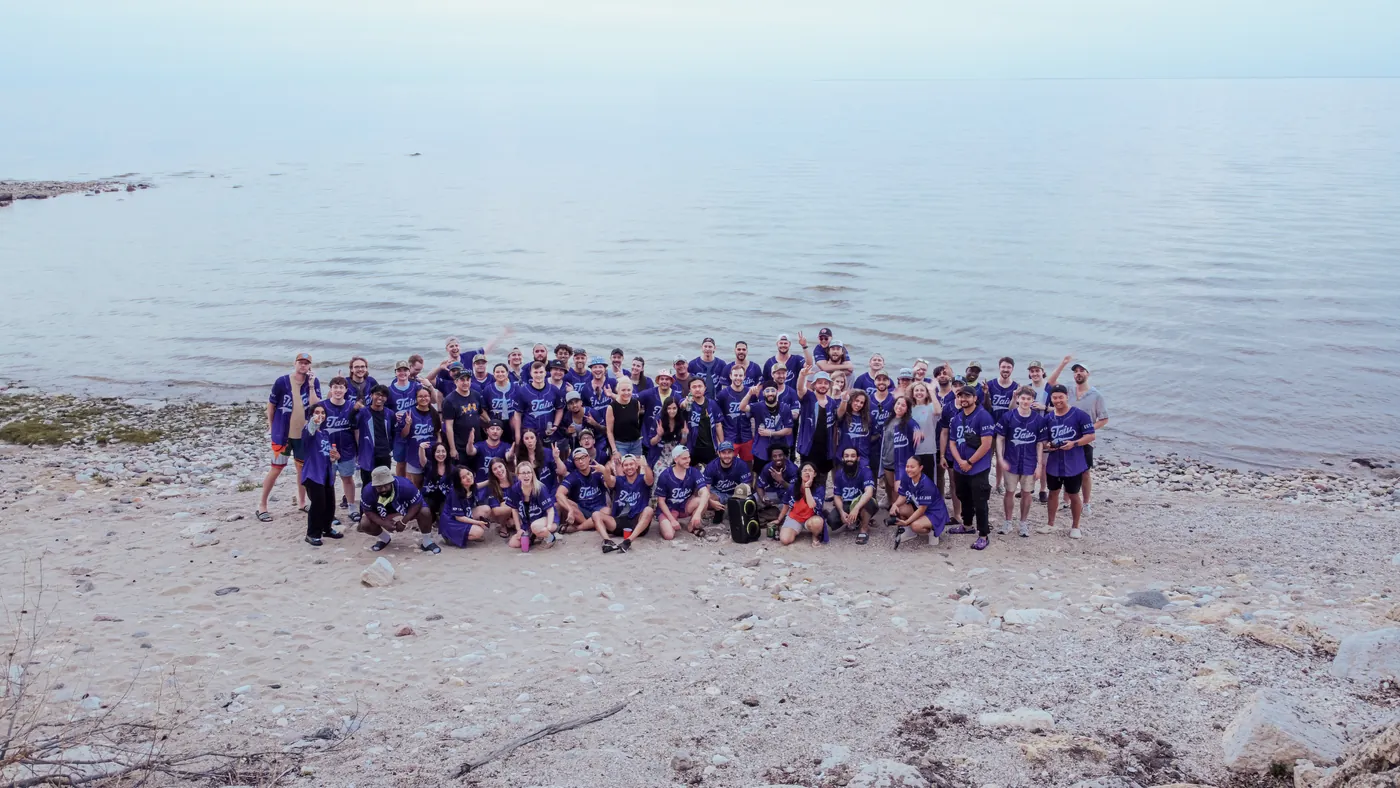 The full Taiv team in team jerseys on the lakeshore