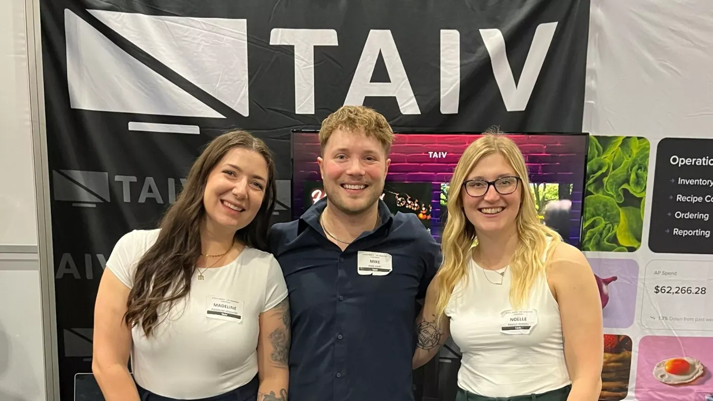 Taiv teammates at a trade-show booth