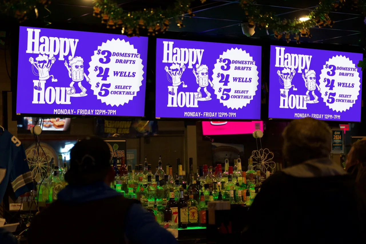 The same pub with all three TVs running the venue’s own Happy Hour promotion